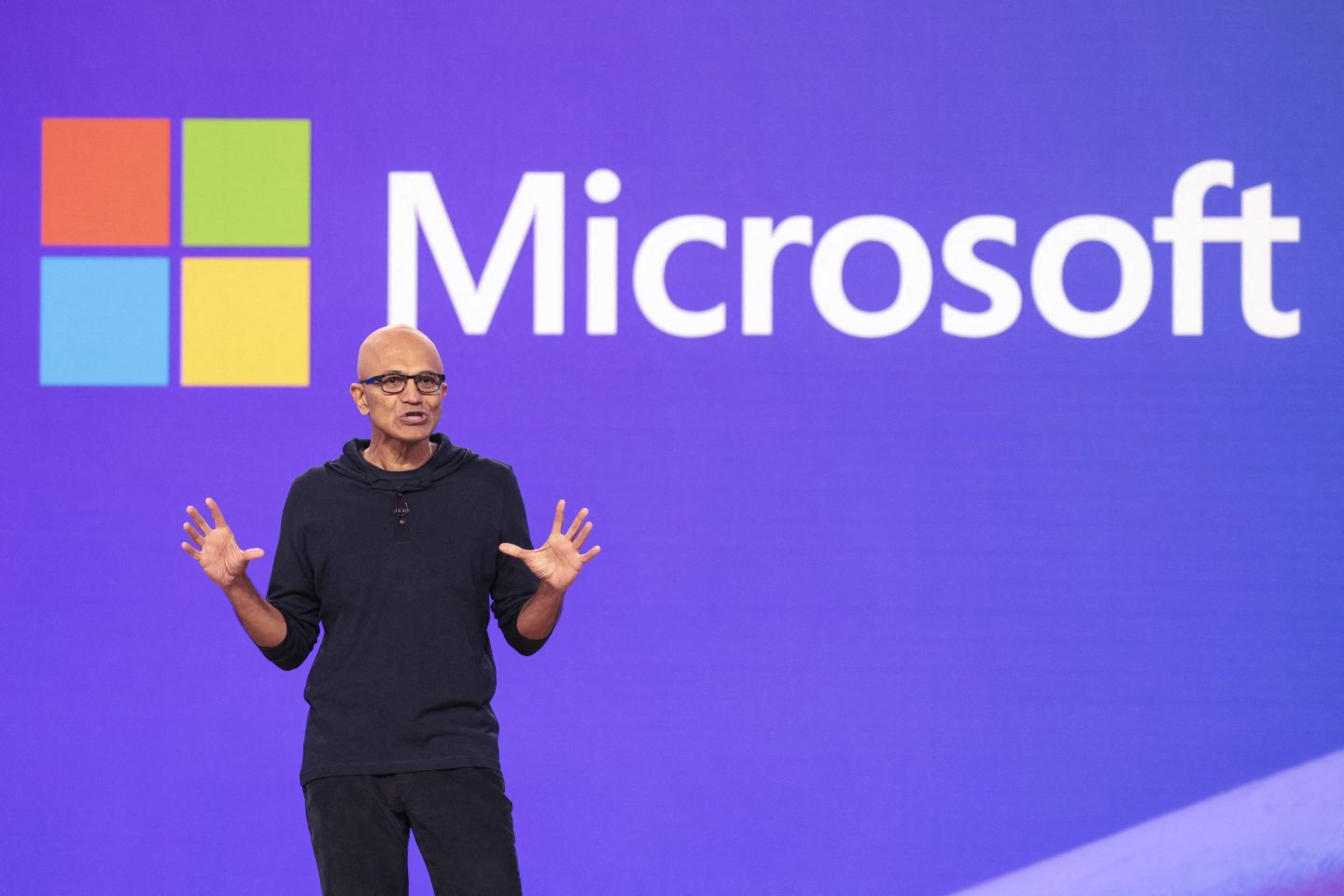 Microsoft CEO Satya Nadella speaks at the Microsoft Build conference in Seattle this year in front of a screen displaying the Microsoft logo.