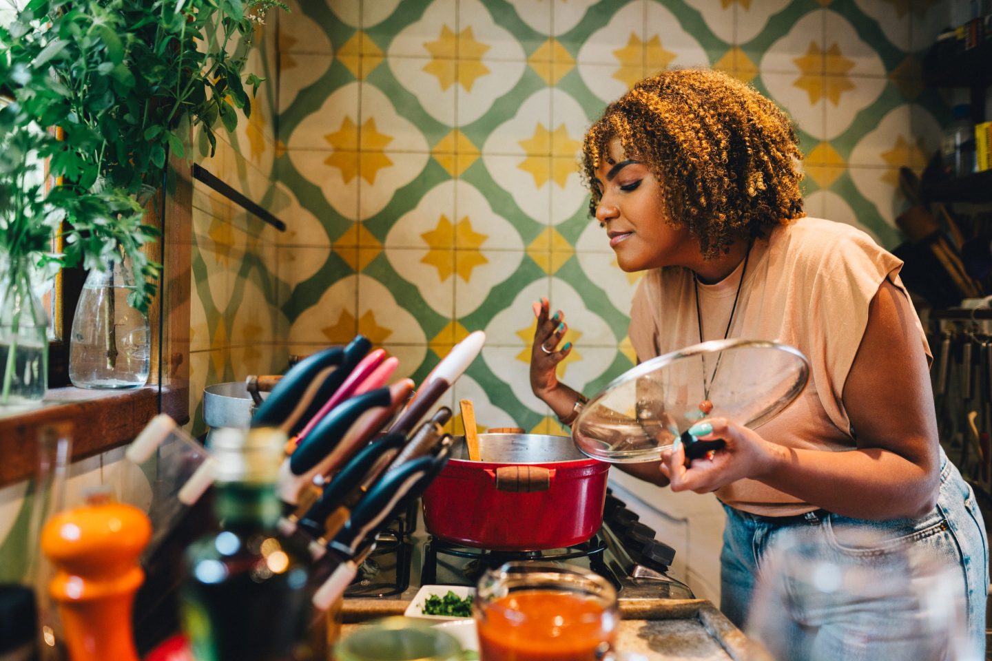 woman smelling food from a caserole