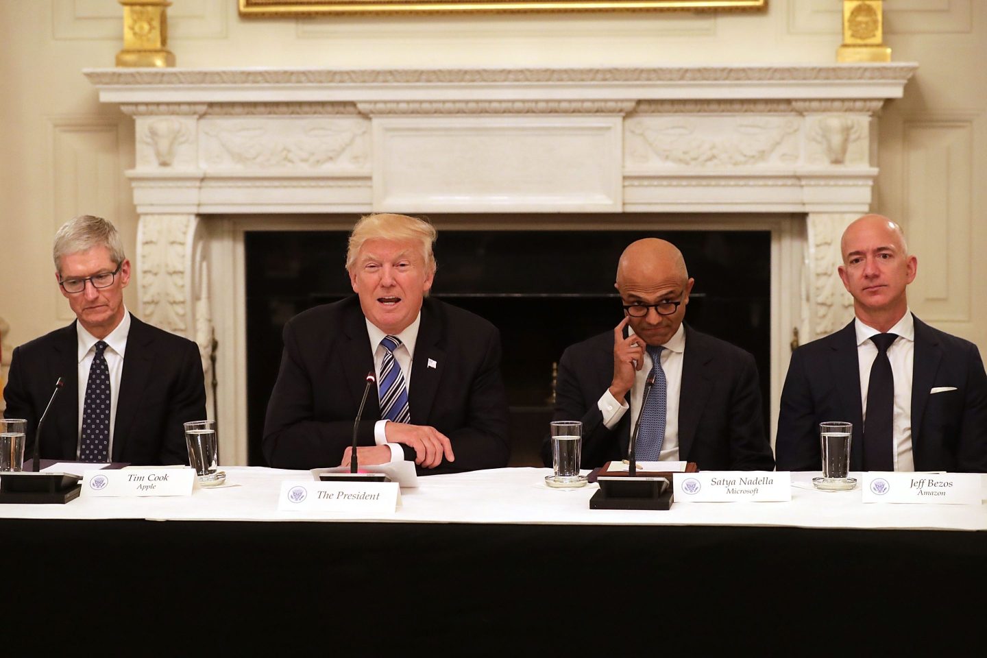 U.S. President Donald Trump (2nd L) welcomes members of his American Technology Council, including (L-R) Apple CEO Tim Cook, Microsoft CEO Satya Nadella and Amazon CEO Jeff Bezos in the State Dining Room of the White House June 19, 2017.