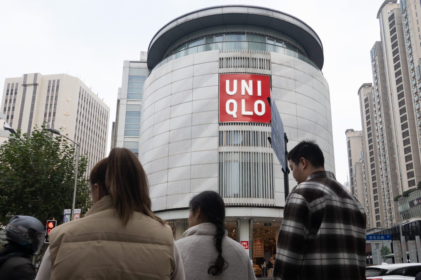 Customers pass by Uniqlo's global flagship store as it celebrates its 40th anniversary in Shanghai, on Dec. 3, 2024.