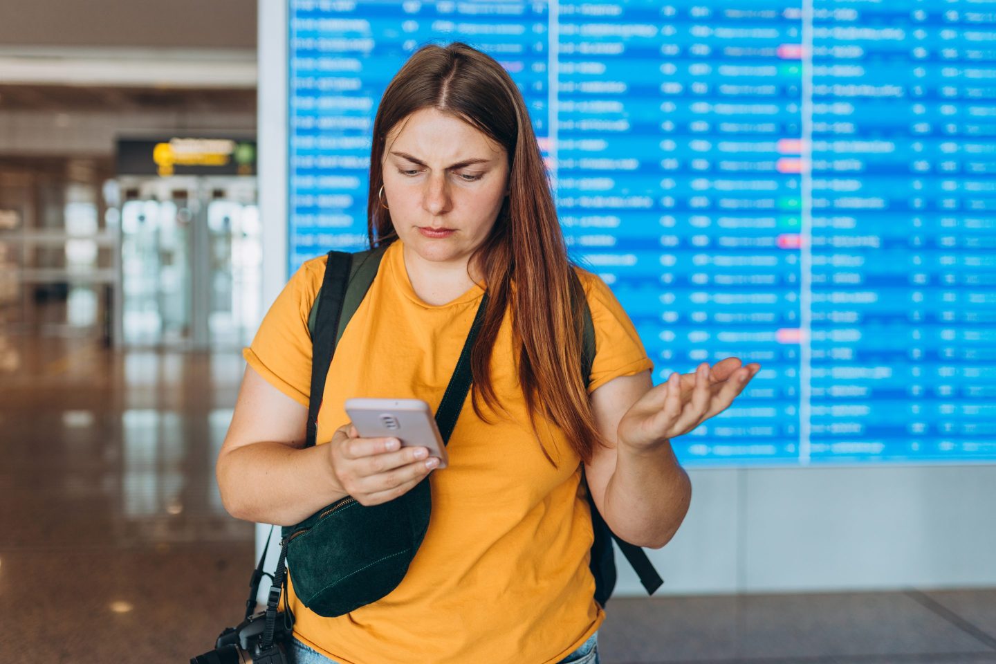 woman checking phone at airport