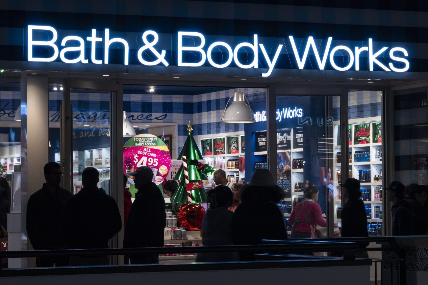 Shoppers walk by a Bath and Body Works store