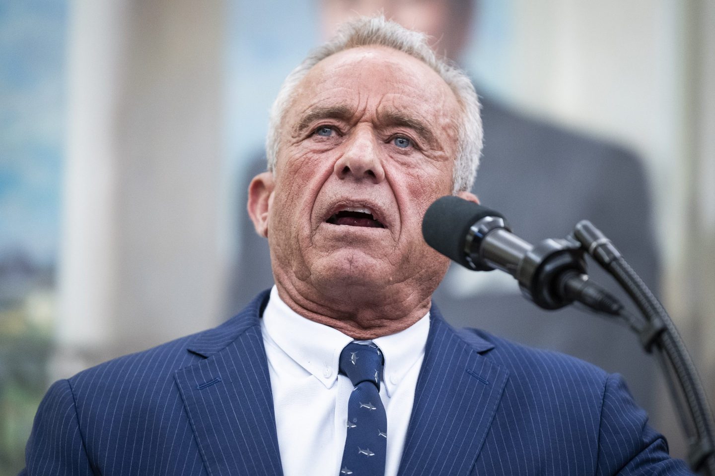 RFK Jr. speaks in front of a microphone