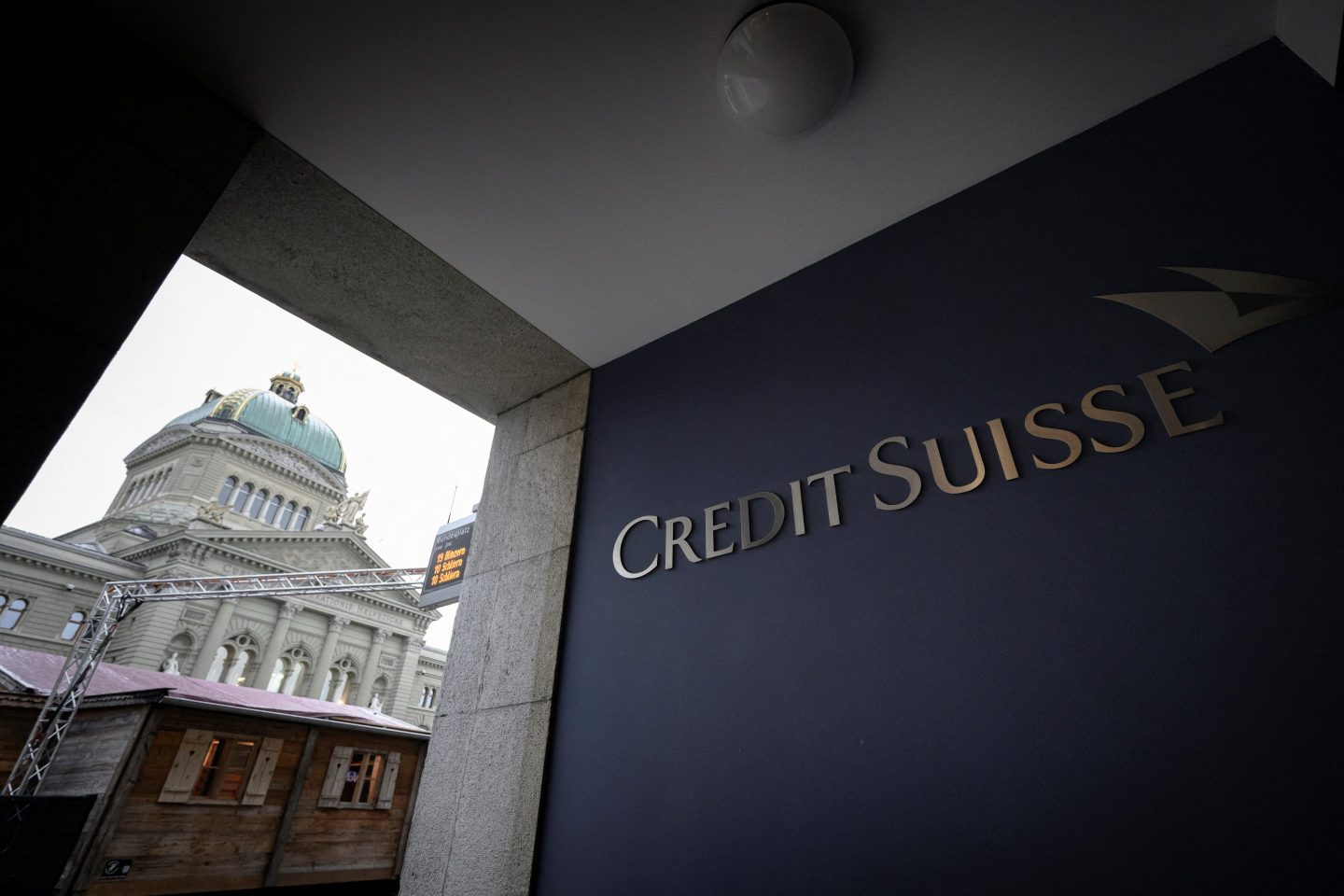 This photograph shows the logo of Swiss bank Credit Suisse with the Swiss House of Parliament in the background in Bern on December 20, 2024, as the country&#039;s financial regulator was ineffective in tackling the scandals at Credit Suisse, where executive mismanagement scuppered the bank and nearly triggered another global financial crisis, a Swiss inquiry concluded today. After an 18-month investigation raking over the dramatic collapse of one of the world&#039;s biggest banks, the rare parliamentary commission of inquiry found no evidence that the implosion of Credit Suisse was caused by misconduct on the part of the authorities. (Photo by GABRIEL MONNET / AFP) (Photo by GABRIEL MONNET/AFP via Getty Images)