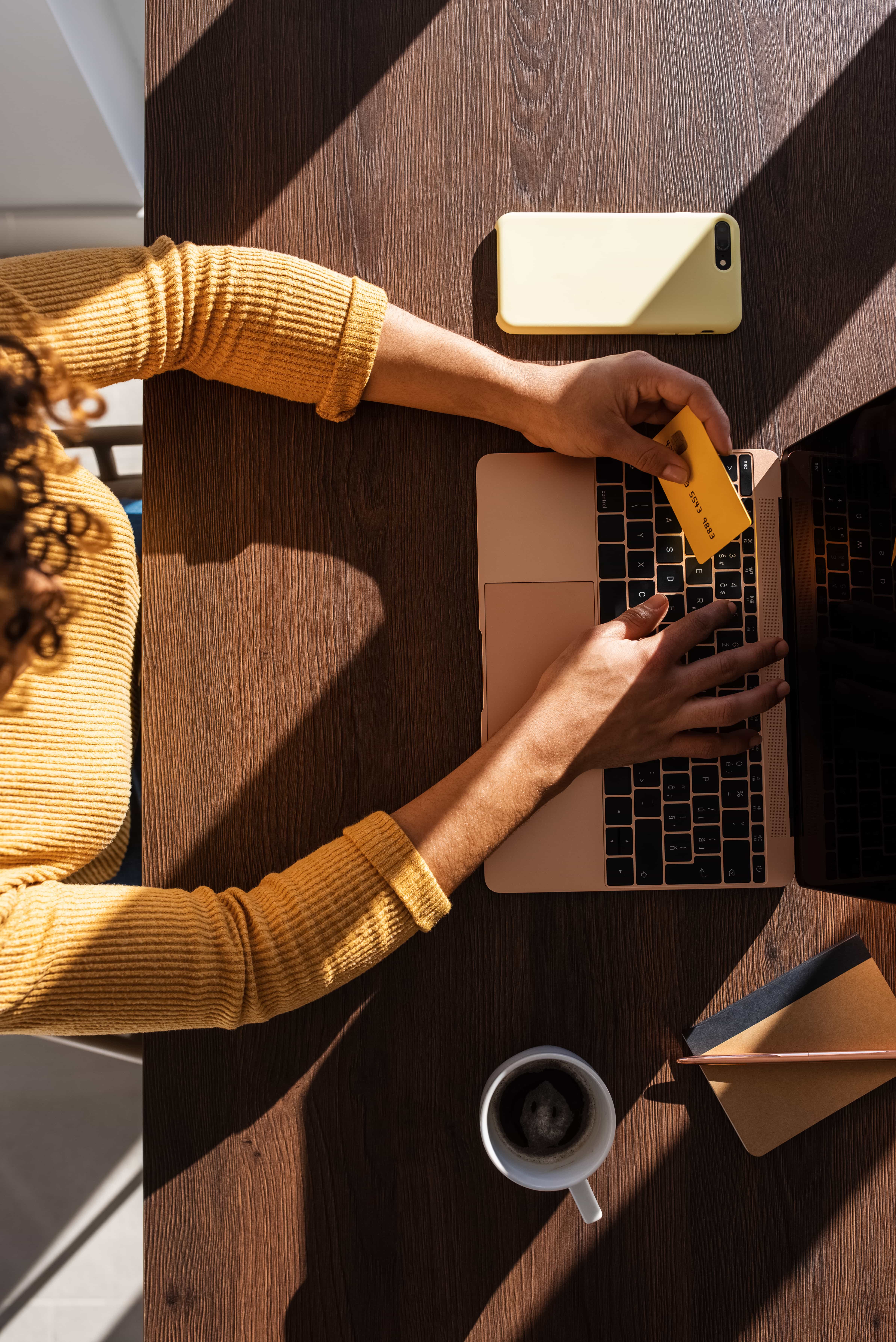 A person using credit card with their laptop.