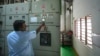 (FILE) Electrician checks the parameter of output breaker of 500 KW Battery Energy storage system inside the Hindustan Coca-Cola Beverages factory in Thiruvallur district, on the outskirts of Chennai, India, Tuesday, July16, 2024.