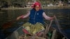 (FILE) A fisherwoman throwing a net to catch the fish on the Phewa lake in Pokhara. Photo by Rajneesh Bhandari/Nepal.