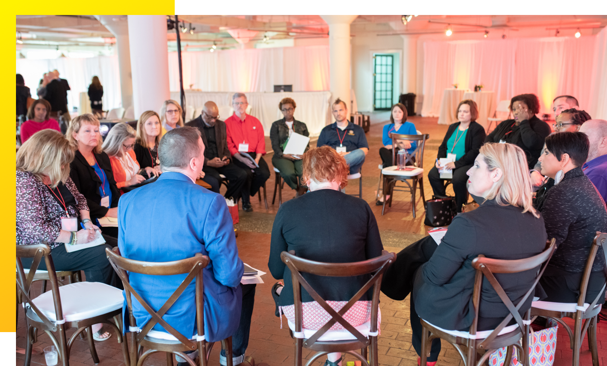 WWA-4 Group of 19 people sitting in chairs arranged in a circle, in discussion
