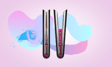 vertical dyson corrale hair straightener against pink background