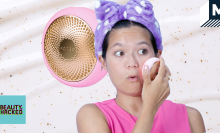 Girl wearing a purple fluffy headband moves a pink puck-shaped object over her face. The puck is also superimposed in the background.