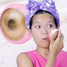 Girl wearing a purple fluffy headband moves a pink puck-shaped object over her face. The puck is also superimposed in the background.