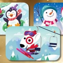 three target gift cards layered on a gold background: starting from the left is a card with two penguins sledding, top right has two snowmen waving, and in the middle is bullseye the target dog skiing