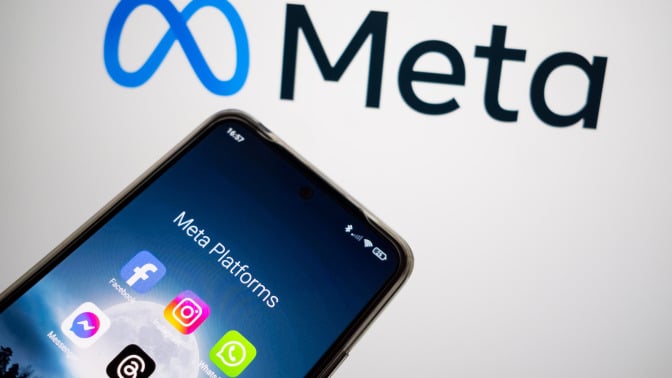 An image of Meta's logo with a phone displaying different Meta company apps. 