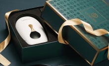 White hair removal device in green and gold box