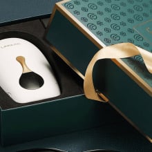 White hair removal device in green and gold box