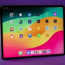 An iPad Air on a purple background