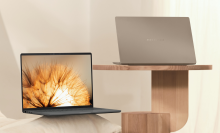 the asus zenbook a14 on a wood table and a white pillow