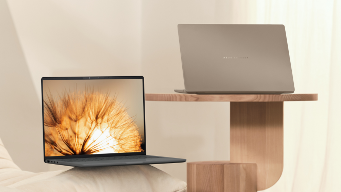 the asus zenbook a14 on a wood table and a white pillow