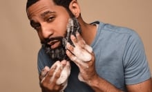 Person washing beard with foam