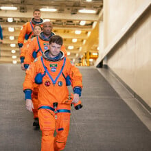 Artemis II crew walking down a ramp