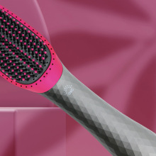 Pink and grey hairbrush over pink background