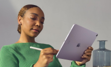 A person holding an iPad Air