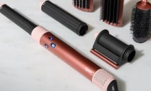 bronze and pink dyson airwrap and attachments on a table