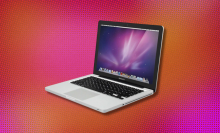 The 13-inch MacBook Pro overlaid on a bright, orange-pink background