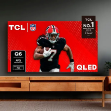 Living room scene featuring TV stand with TCL TV with football player on screen