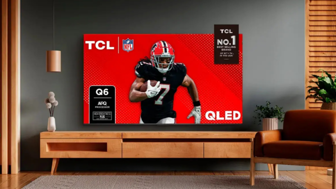 Living room scene featuring TV stand with TCL TV with football player on screen