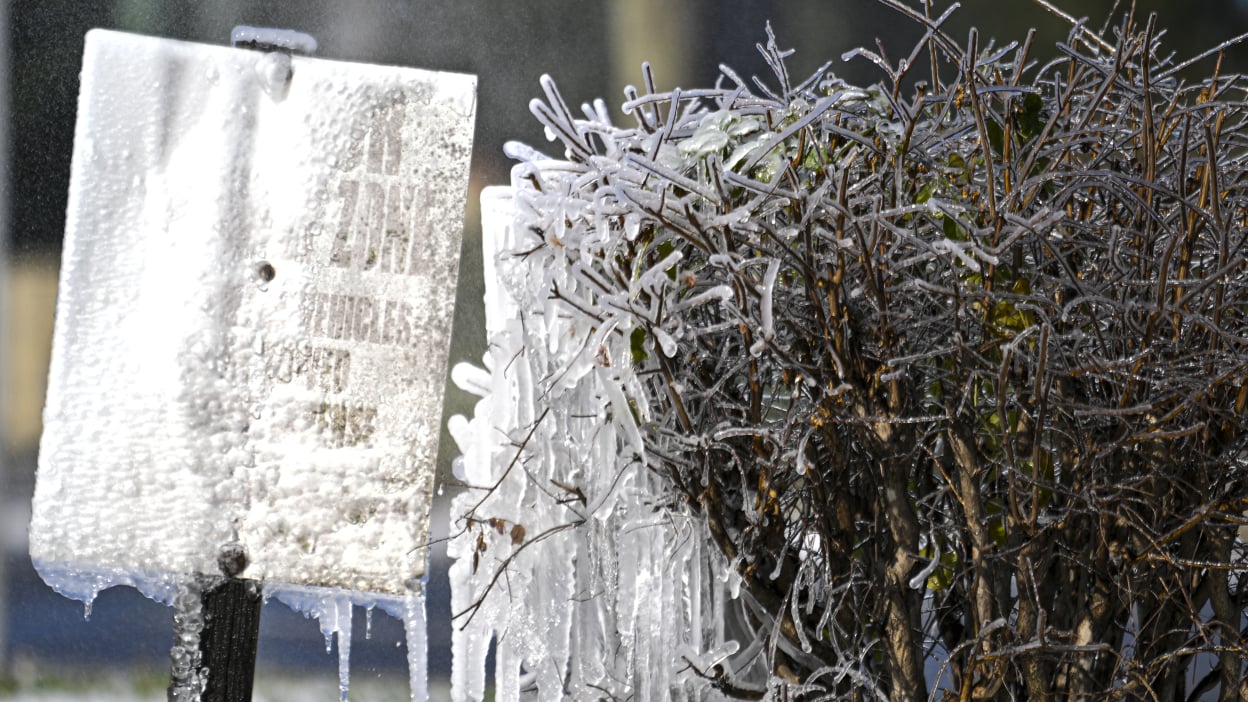 A road sign is covered in snow and ice following an historic winter storm on January 22, 2025 in Tallahassee, Florida