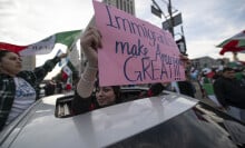 A protester holds up a sign that reads "Immigrants Make America Great!"