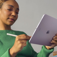 woman holding purple iPad Air with Apple Pencil