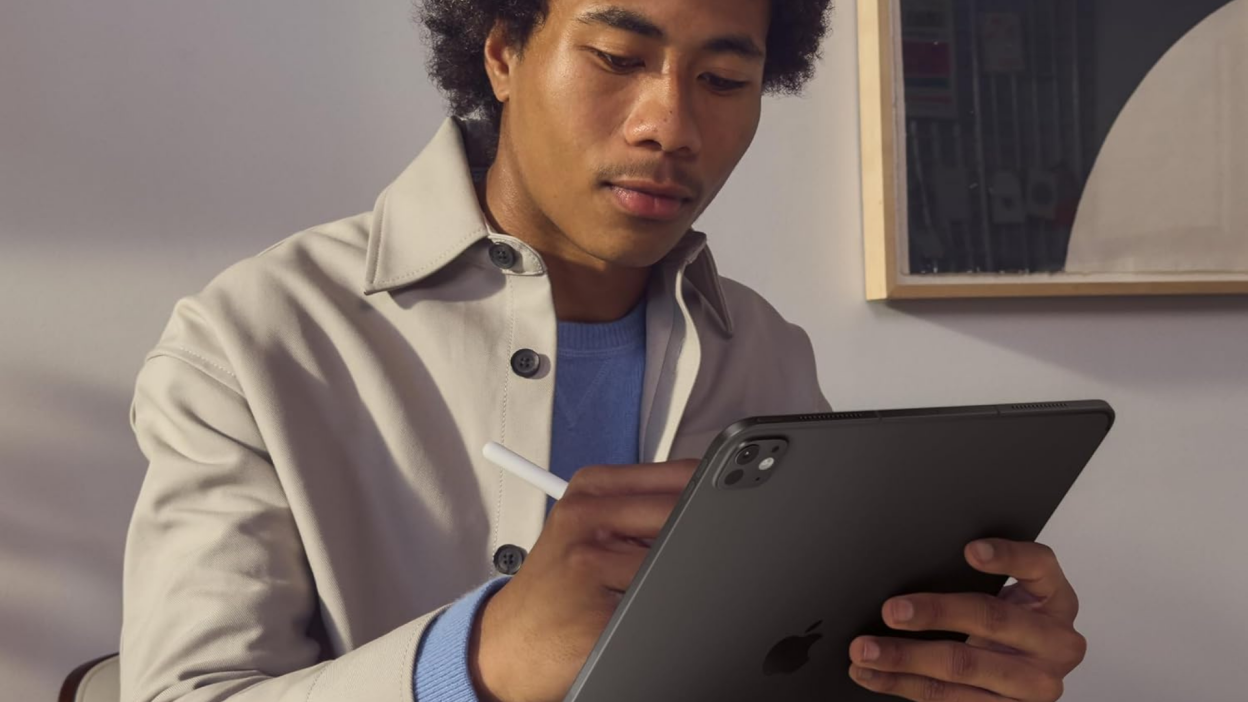 A person holding an iPad Pro