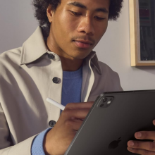 A person holding an iPad Pro