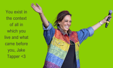 Kamala Harris in a rainbow embellished jean jacket, with her hands up in a "v" shape and a mic in one hand. The background is "brat" green, with text that reads  "You exist in the context of all in which you live and what came before you, Jake Tapper <3"