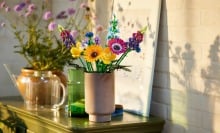 a lego wildflower bouquet sits in a vase on a table inside a home