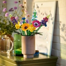 a lego wildflower bouquet sits in a vase on a table inside a home