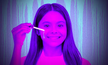 A girls applying serum in spooky purple and pink lighting. 