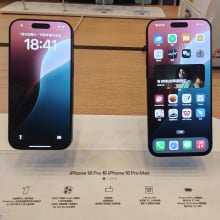 Two iPhones laying on a table at the Apple Store