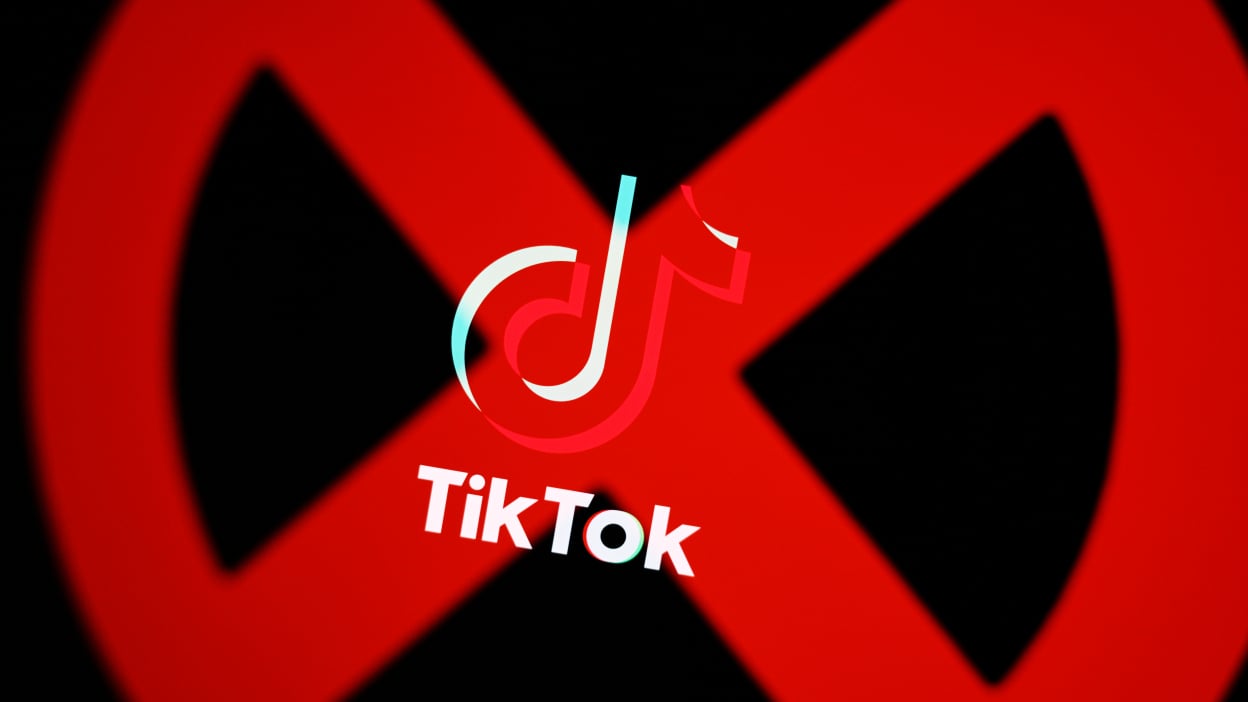 A large red "X" over the TikTok logo