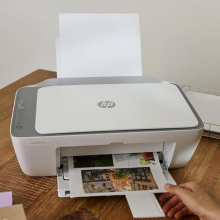 A person printing photos with an HP printer