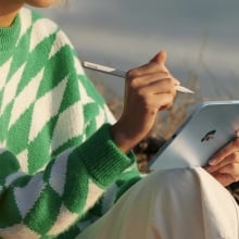 person using apple pencil on blue ipad mini released in 2024