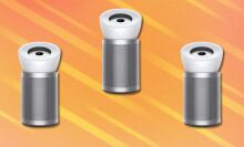 three dyson air purifiers on an orange background