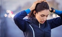 woman in exercise clothes with hands on head wearing jabra elite 8 active gen 2 earbuds