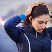 woman in exercise clothes with hands on head wearing jabra elite 8 active gen 2 earbuds