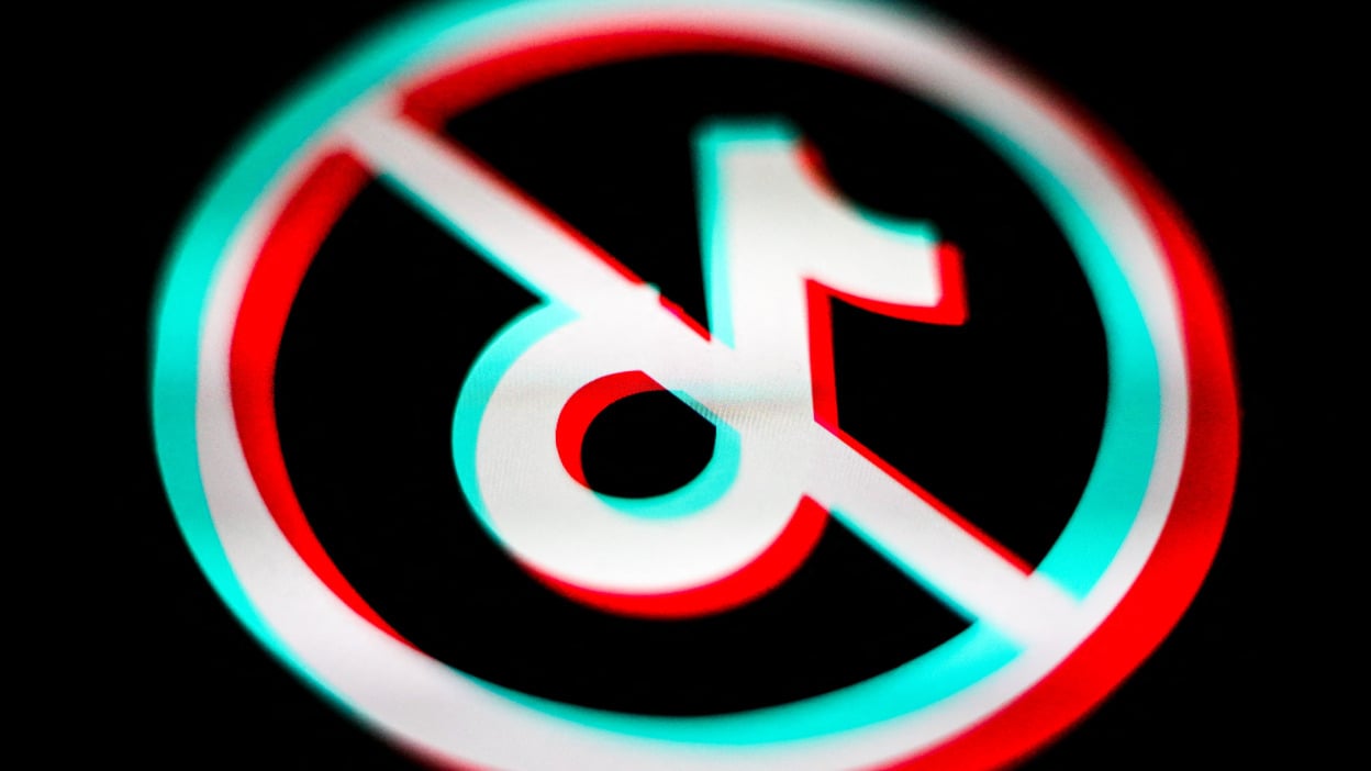 The TikTok logo within a circle and a line crossed through it.