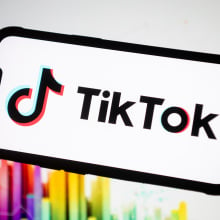 TikTok logo displayed on a phone screen. 