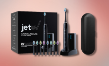 black jetwave toothbrush, brush heads, and travel case with pink background