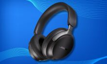 black bose quietcomfort ultra headphones on a blue background with soundwaves across the top and bottom